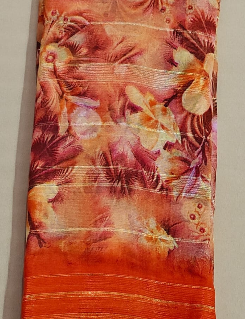 Sunset Orange Floral Georgette Saree with Metallic Stripes & Tribal Accents
